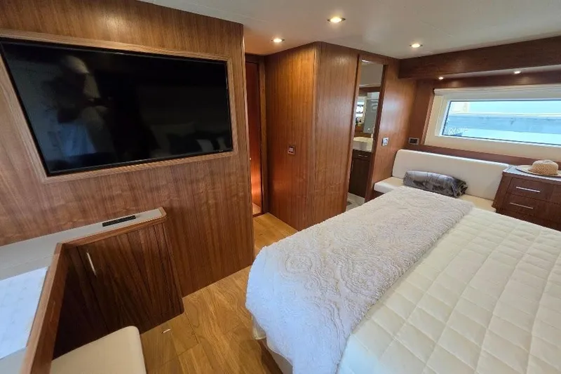 Slide: The Image of Luxurious bedroom interior of 2024 Sirena 58 Flybridge MY yacht with wood paneling. - 116
