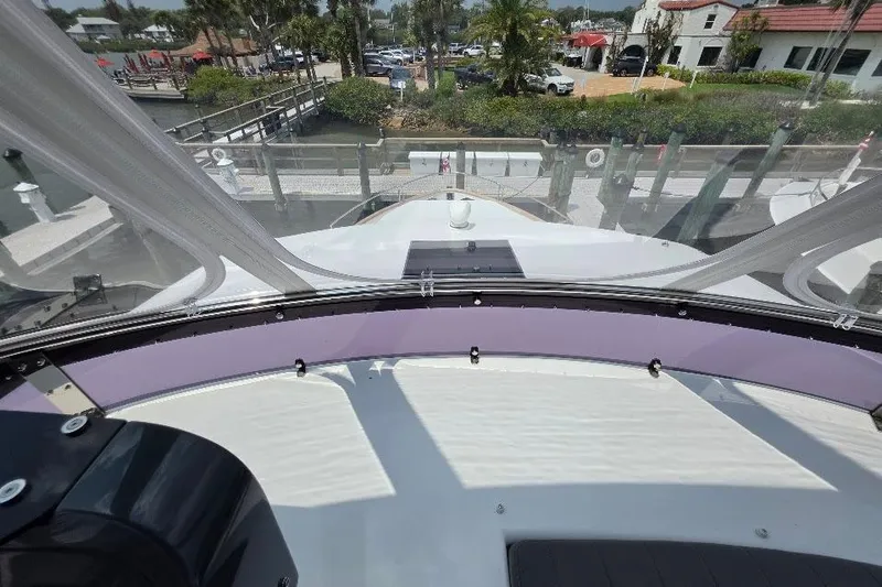 Slide: The Image of 2024 Sirena 58 Flybridge MY yacht helm view with marina backdrop. - 32