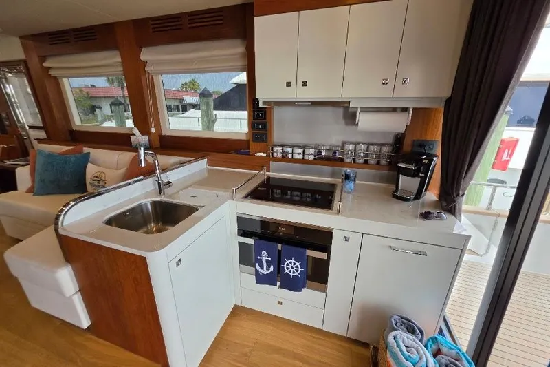 Slide: The Image of Modern kitchen interior on 2024 Sirena 58 Flybridge yacht, featuring sleek design and amenities. - 59