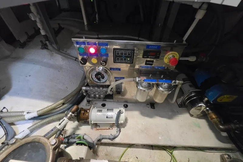 Slide: The Image of Engine room of 2024 Sirena 58 Flybridge MY yacht, featuring control panel and machinery. - 128