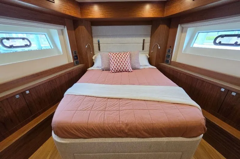 Slide: The Image of Luxurious bedroom interior of 2024 Sirena 58 Flybridge MY yacht with elegant wood finishes. - 102