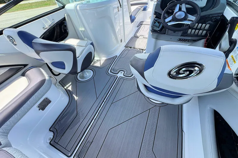 Slide: The Image of 2023 Hurricane SunDeck 2410 OB interior with modern seating and sleek steering console. - 12