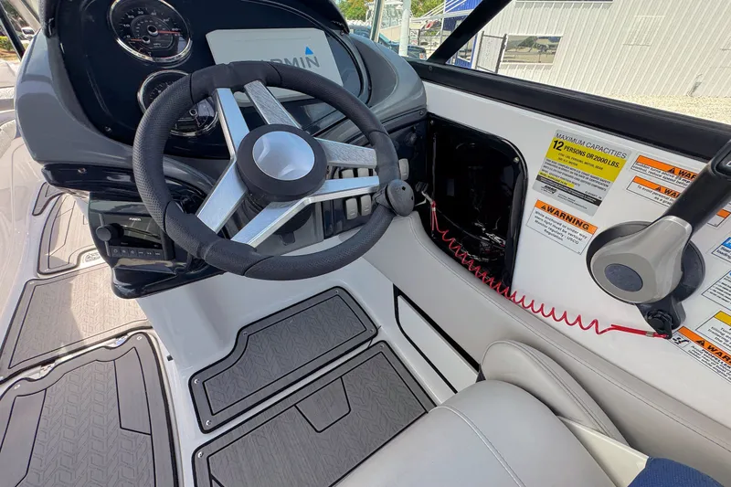 Slide: The Image of 2023 Hurricane SunDeck 2410 OB boat cockpit with steering wheel and control panel. - 13