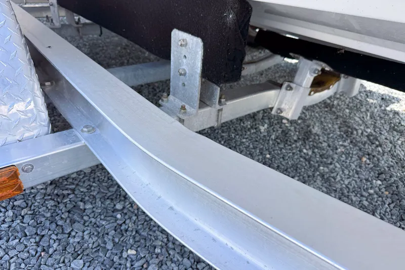 Slide: The Image of Trailer frame of 2023 Hurricane SunDeck 2410 OB on gravel surface. - 8