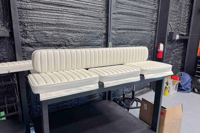 Slide: The Image of White cushioned seats for 2023 Hurricane SunDeck 2410 OB boat in a workshop setting. - 22