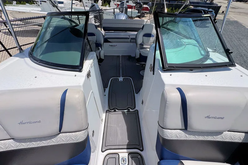 Slide: The Image of 2023 Hurricane SunDeck 2410 OB boat interior with seating and windshield. - 20