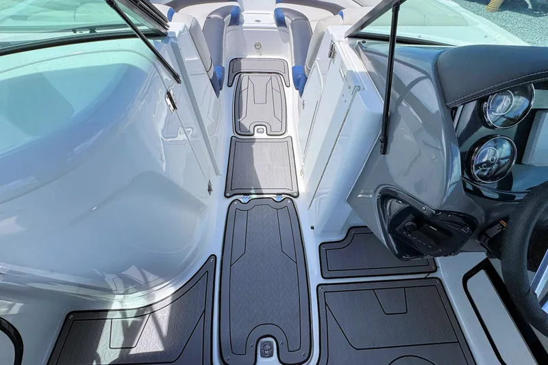 Slide: The Image of Interior view of 2023 Hurricane SunDeck 2410 OB boat, featuring sleek design and modern dashboard. - 16