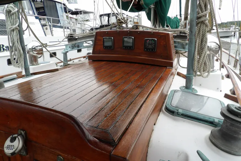 Slide: The Image of 1986 Hans Christian 43 T sailboat with polished wooden deck and navigation instruments. - 13