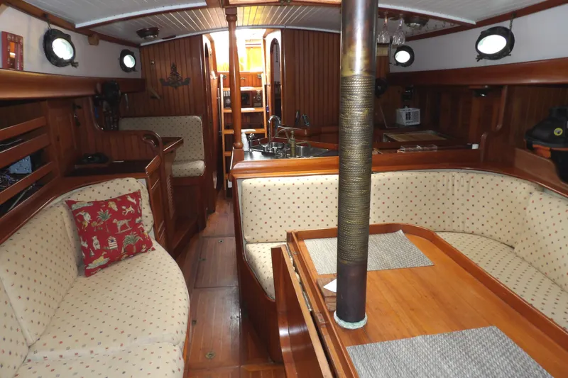 Slide: The Image of Interior of 1986 Hans Christian 43 T sailboat with wooden furnishings and cozy seating. - 49