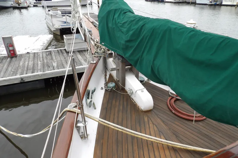 Slide: The Image of Deck of 1986 Hans Christian 43 T sailboat with green cover at marina. - 23