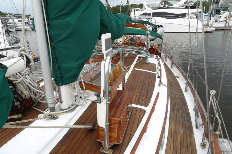 Slide: The Image of 1986 Hans Christian 43 T sailboat with wooden deck and green covers docked at marina. - 22