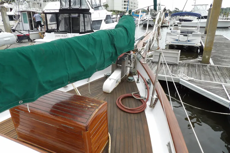 Slide: The Image of 1986 Hans Christian 43 T sailboat docked at marina with green sail cover. - 24