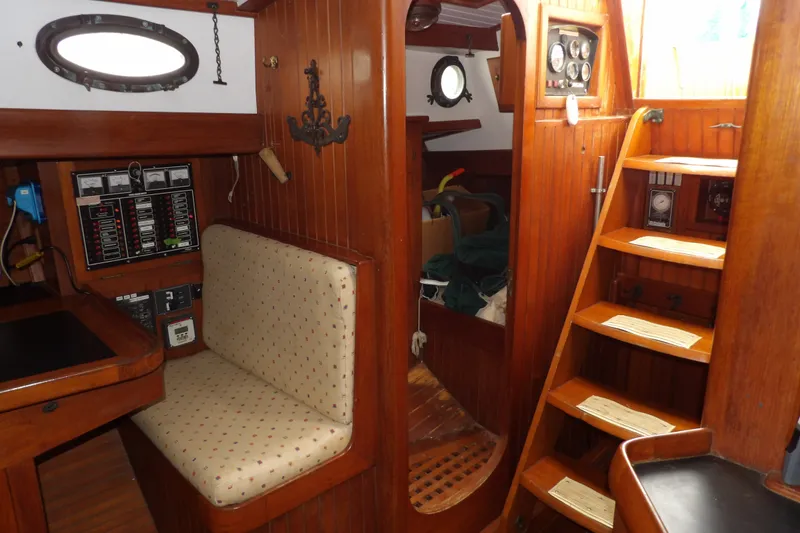 Slide: The Image of Interior of 1986 Hans Christian 43 T sailboat with wooden paneling and navigation station. - 36