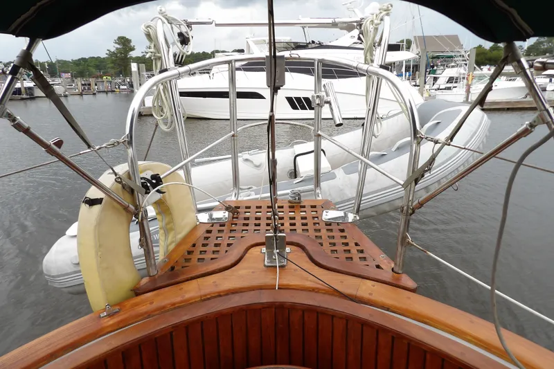 Slide: The Image of Cockpit view from 1986 Hans Christian 43 T sailboat, featuring marina and inflatable dinghy. - 16