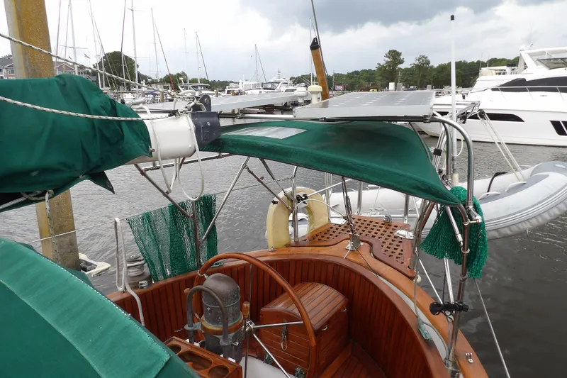 Slide: The Image of 1986 Hans Christian 43 T sailboat with green canopy and solar panels docked at marina. - 18