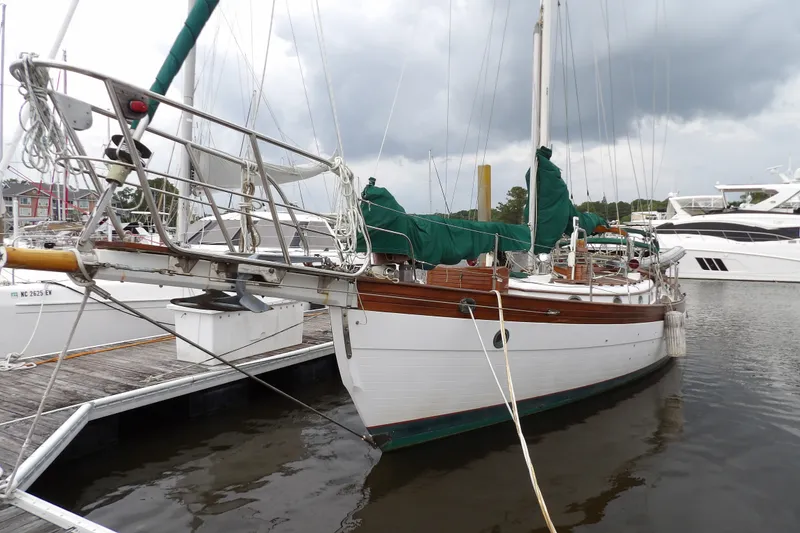 Slide: The Image of 1986 Hans Christian 43 T sailboat docked at marina under cloudy sky. - 2
