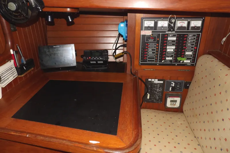 Slide: The Image of Navigation station of a 1986 Hans Christian 43 T sailboat with control panel and seating. - 45
