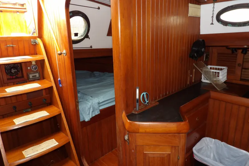 Slide: The Image of Interior of 1986 Hans Christian 43 T sailboat with wooden paneling and cozy cabin space. - 34