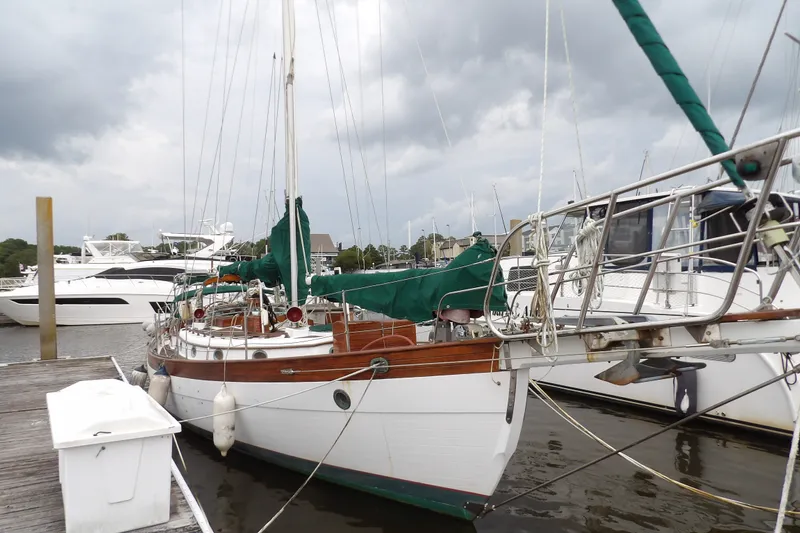 Slide: The Image of 1986 Hans Christian 43 T sailboat docked at marina under cloudy skies. - 3