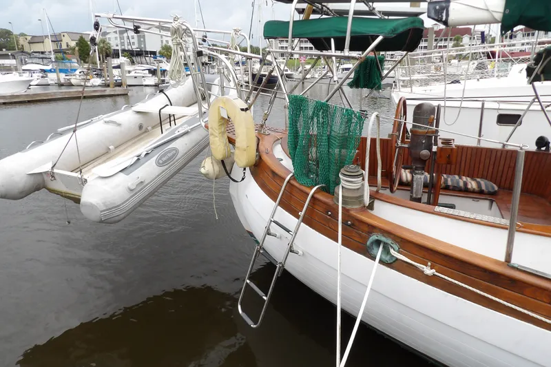 Slide: The Image of 1986 Hans Christian 43 T sailboat docked with dinghy and nautical equipment. - 7