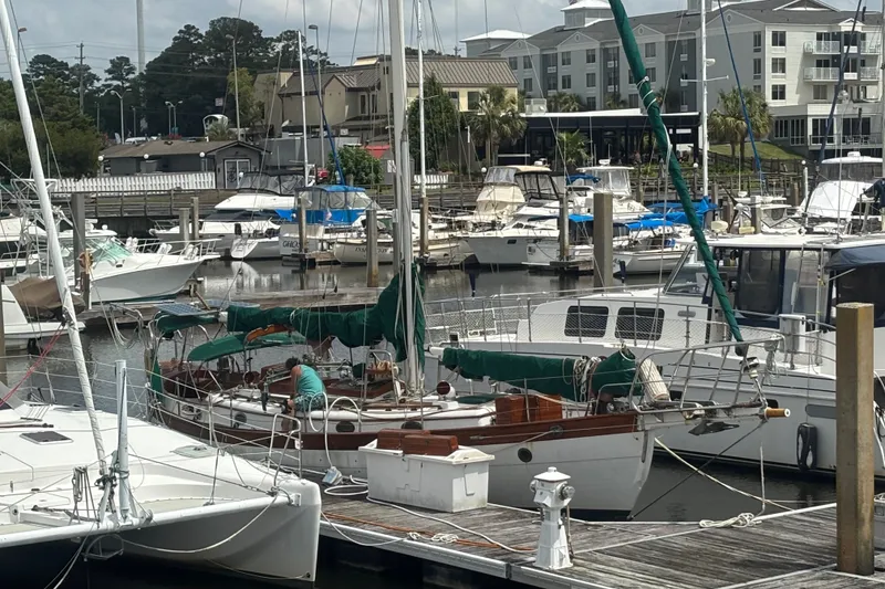 Slide: The Image of Sailboats docked at a marina, featuring a 1986 Hans Christian 43 T. - 5