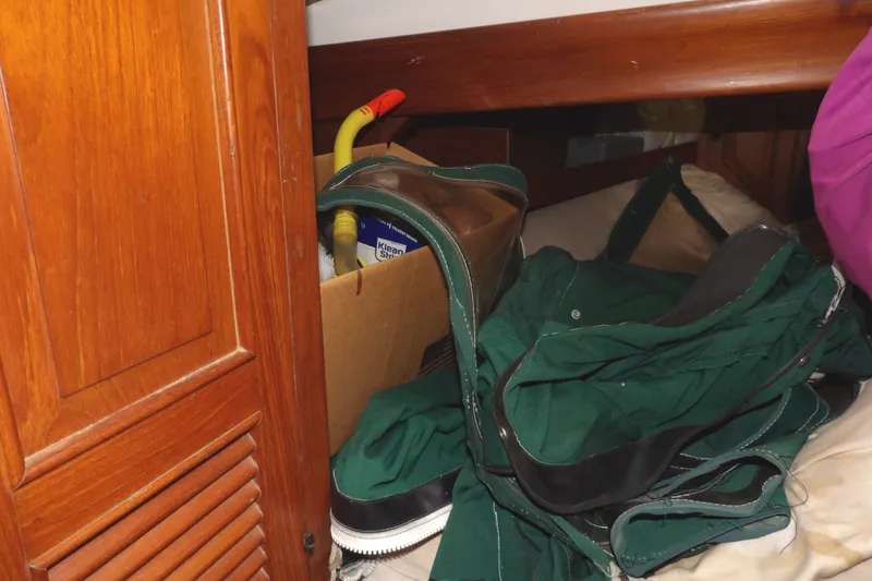 Slide: The Image of Interior of 1986 Hans Christian 43 T sailboat with storage items and green fabric. - 37