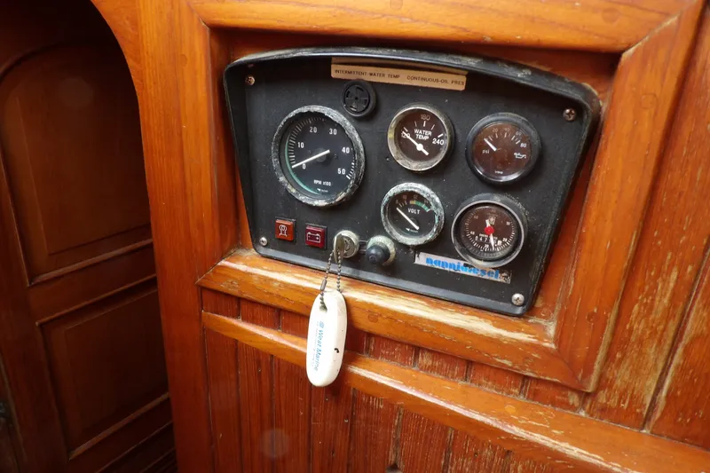 Slide: The Image of Control panel of a 1986 Hans Christian 43 T sailboat with gauges and key. - 32