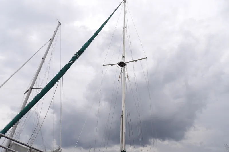 Slide: The Image of Tall mast of 1986 Hans Christian 43 T sailboat against cloudy sky. - 52
