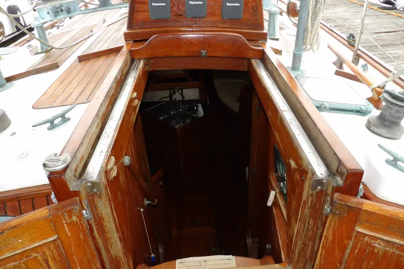 Slide: The Image of 1986 Hans Christian 43 T sailboat interior entrance with wooden finish and nautical equipment. - 31