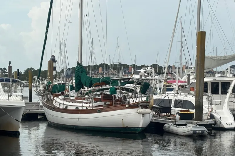 Slide: The Image of Sailboat Hans Christian 43 T, 1986 model, docked in a marina with other boats. - 4