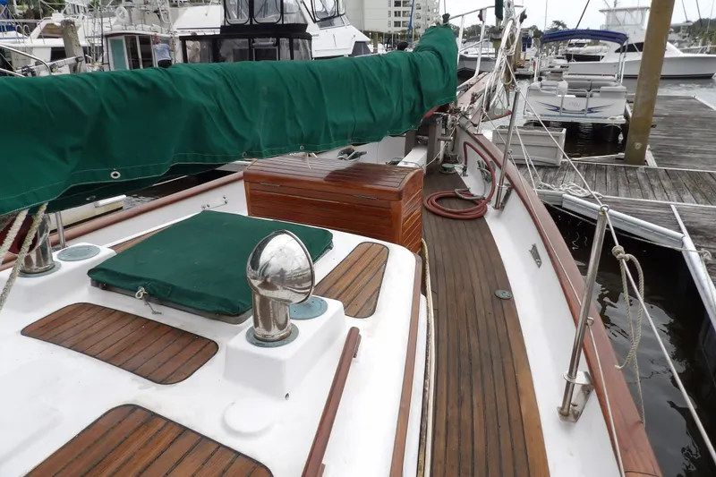 Slide: The Image of 1986 Hans Christian 43 T sailboat with green covers docked at a marina. - 27