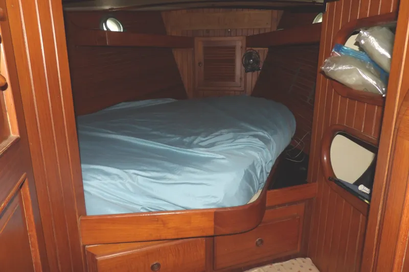 Slide: The Image of Cozy cabin interior of 1986 Hans Christian 43 T sailboat with wooden finish and bed. - 46