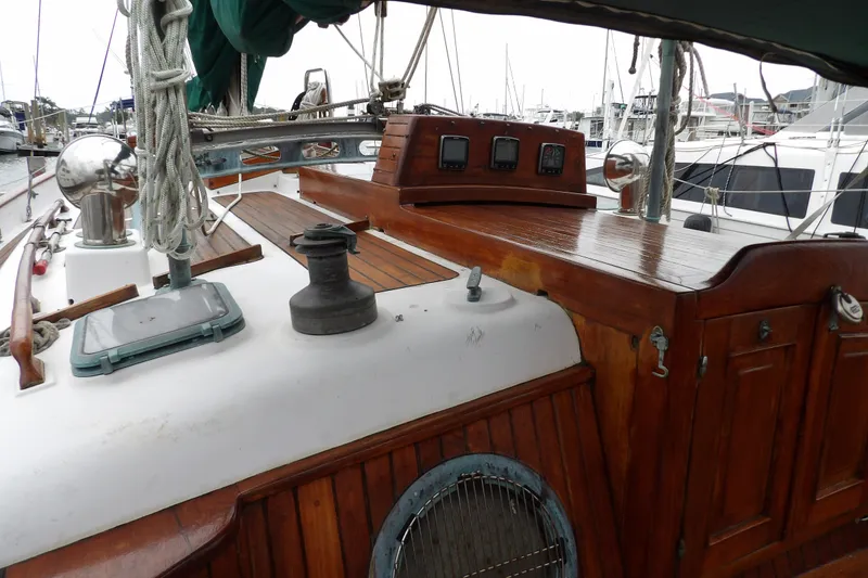 Slide: The Image of 1986 Hans Christian 43 T sailboat deck with wooden finish and nautical equipment. - 14