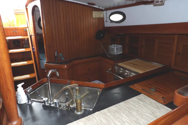 Slide: The Image of 1986 Hans Christian 43 T yacht interior with wooden cabinetry and kitchen area. - 40