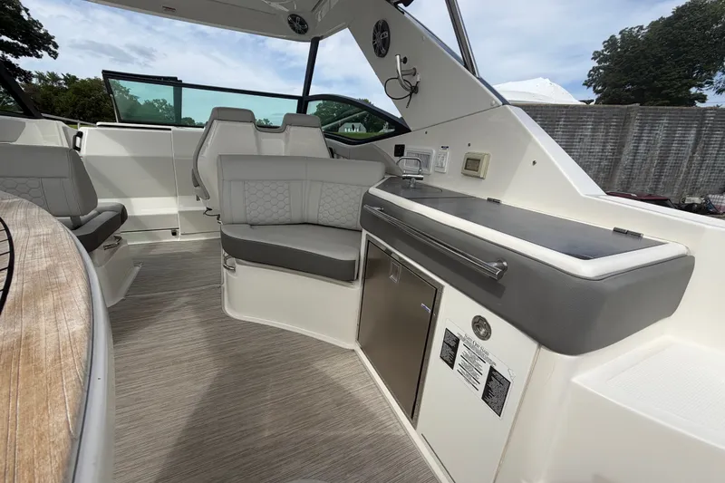 Slide: The Image of 2021 Sea Ray Sundancer 320 interior with modern seating and sleek kitchenette. - 13