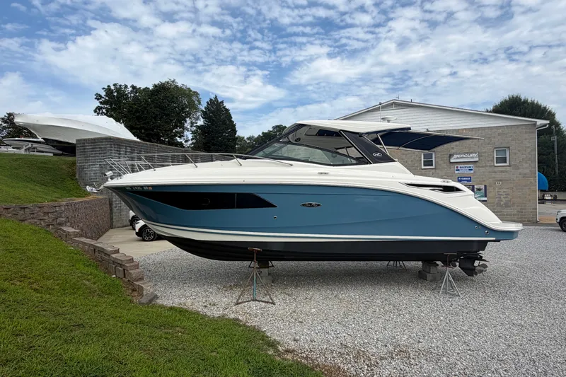 Slide: The Image of 2021 Sea Ray Sundancer 320 boat displayed outdoors on gravel. - 6