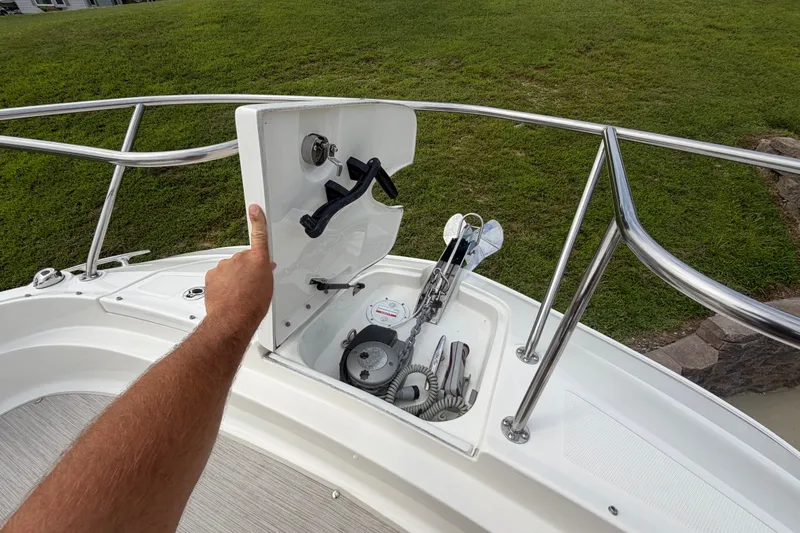 Slide: The Image of 2021 Sea Ray Sundancer 320 anchor compartment with stainless steel railing and winch controls. - 46