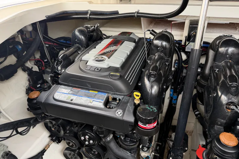 Slide: The Image of Engine compartment of a 2021 Sea Ray Sundancer 320 boat, showcasing detailed mechanics. - 27