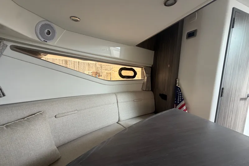 Slide: The Image of Interior of 2021 Sea Ray Sundancer 320 yacht with modern seating and American flag decor. - 42