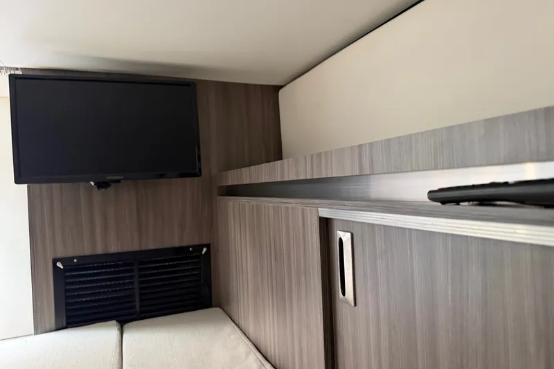 Slide: The Image of Interior of 2021 Sea Ray Sundancer 320 with TV and modern cabinetry. - 31