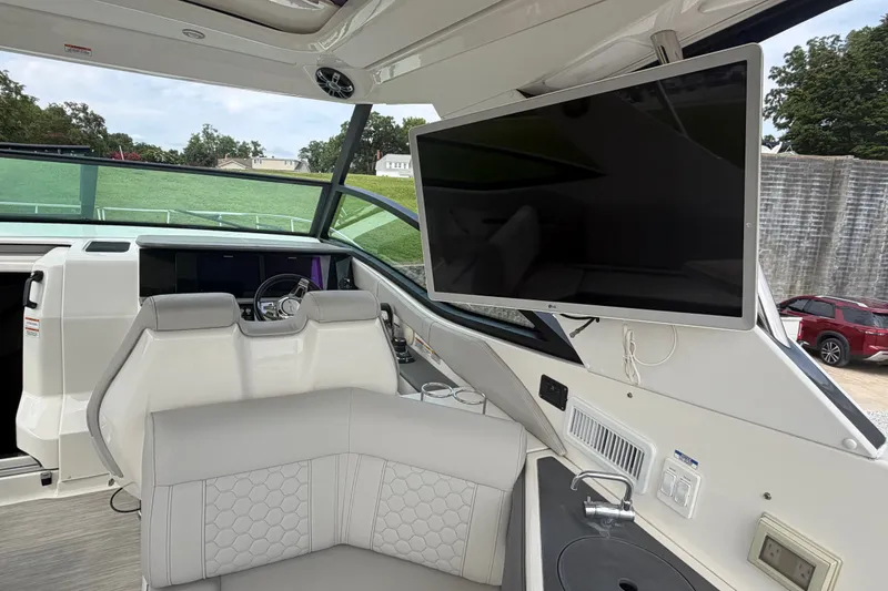 Slide: The Image of Interior of 2021 Sea Ray Sundancer 320 yacht with helm and mounted TV. - 16