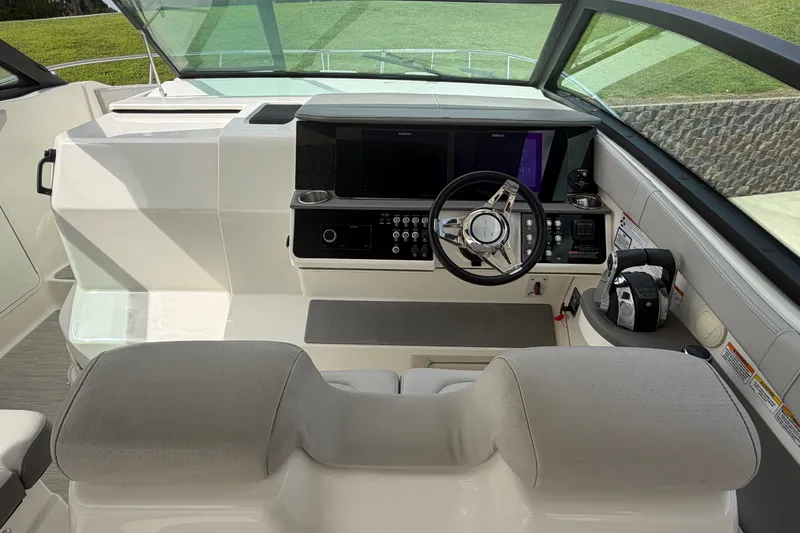 Slide: The Image of Cockpit of 2021 Sea Ray Sundancer 320 with modern steering and controls. - 18