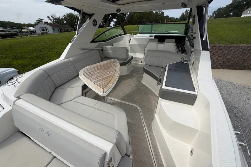 Slide: The Image of Luxurious 2021 Sea Ray Sundancer 320 boat interior with elegant seating and wooden table. - 10