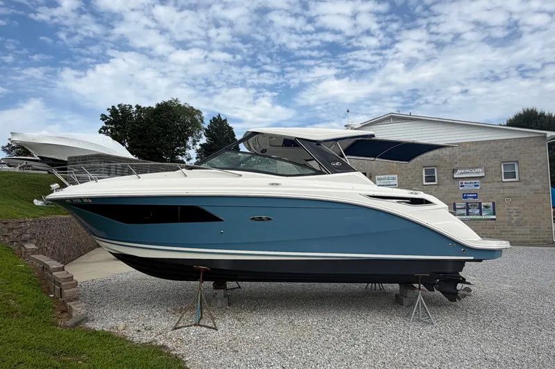 The Image of 2021 Sea Ray Sundancer 320 boat on display, featuring sleek design and blue hull. - 0