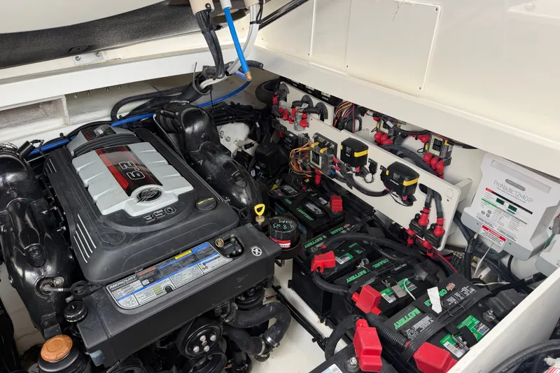 Slide: The Image of Engine compartment of a 2021 Sea Ray Sundancer 320, featuring a MerCruiser 350 engine and battery setup. - 29