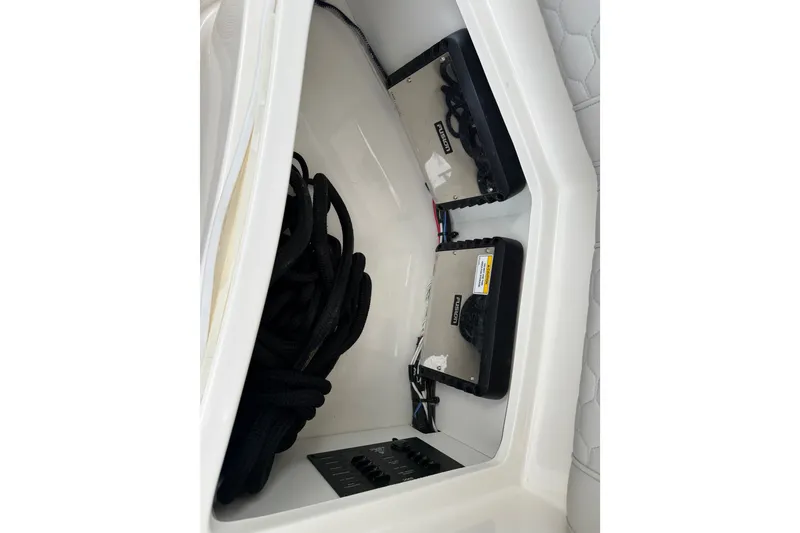 Slide: The Image of Storage compartment in a 2021 Sea Ray Sundancer 320 with ropes and electronic equipment. - 23