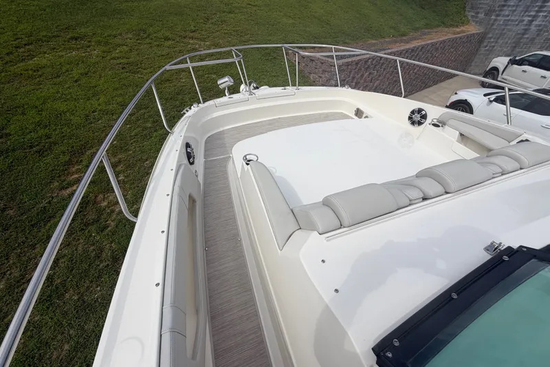 Slide: The Image of 2021 Sea Ray Sundancer 320 boat deck with cushioned seating and railing. - 44