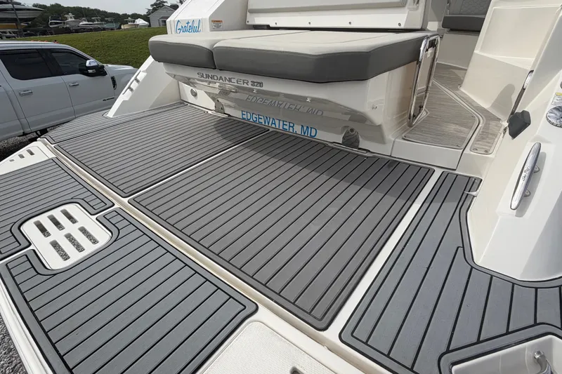 Slide: The Image of 2021 Sea Ray Sundancer 320 boat with spacious deck and seating area. - 8