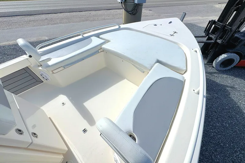 Slide: The Image of 2023 Pathfinder 2200 TRS boat interior with cushioned seating and storage compartments. - 10