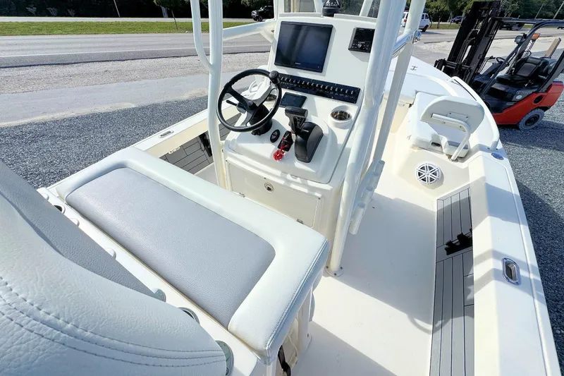 Slide: The Image of 2023 Pathfinder 2200 TRS boat interior with steering console and seating. - 8